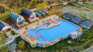 an overhead view of a large pool with a water park at Nature Escape Farm & Resort in Palayan City