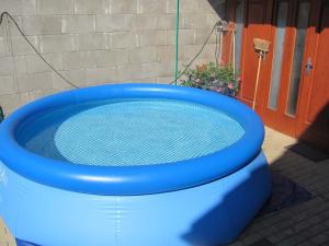 a blue toilet with a swimming pool in it at Rekreační dům Strachotín in Strachotín