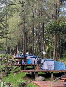 a group of people standing in front of tents at Jolotundo Glamping and Edupark in Sagi