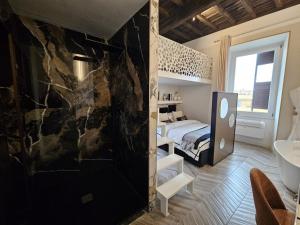 a bedroom with a bed and a rock wall at Be Your Home - My Attitude in Civitavecchia +35 photos