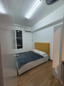 a bedroom with a bed and a window at JT Homestay in Kota Kinabalu
