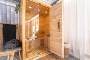 a sauna with wooden walls and a saunavisor at Glamping Happiness - Natural Pool & Wellness in Ribnica +20 photos