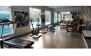 a gym with several exercise equipment in a room at Exotic resort in Gaushala +19 photos