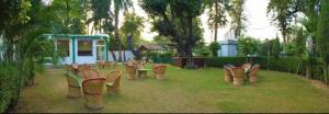 a row of chairs in a park with a playground at Exotic resort in Gaushala