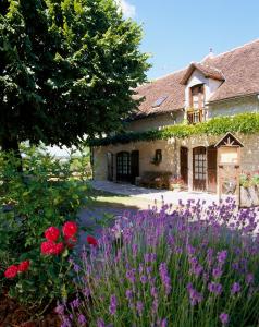 un jardín con flores púrpuras frente a una casa en Belveyre à Rocamadour en Rocamadour