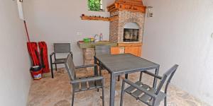 a dining room with a table and chairs and a fireplace at Mariana B4 in Veli Lošinj