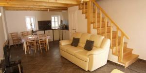 a living room with a couch and a kitchen and a table at Mariana B4 in Veli Lošinj