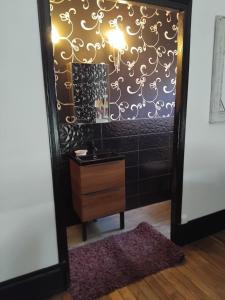 a bathroom with a mirror and a dresser at L'appart in Vinneuf