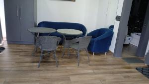 a room with two tables and chairs and a couch at Rusha Stays in Gumgaon