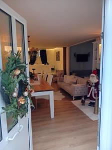 a dining room and living room with a christmas tree at Meteora Grande luxury suite & spa villa in Kalabaka