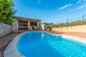 a large blue swimming pool in a backyard at Joli gîte avec piscine in Laval-Saint-Roman