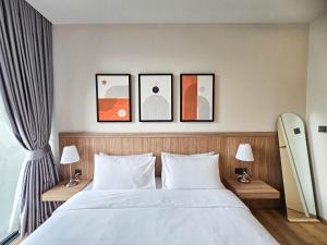 a bedroom with a bed with four pictures on the wall at Wora Phuket in Ban Sam Kong +282 photos