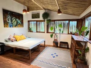 a living room with a couch and a table at Casa Hwinzo at Hwinzo Retreat, Tofo in Praia do Tofo