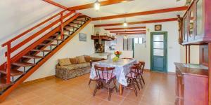 a kitchen and living room with a table and a staircase at Tia in Veli Lošinj