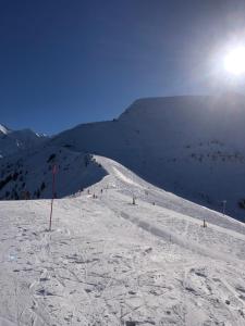 a group of people skiing down a snow covered slope at Appartement St Nicolas in Saint-Gervais-les-Bains