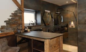 a bathroom with a wooden table and a sink at L'Autentic in Aussois +24 photos