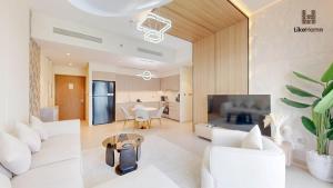 Una sala de estar con un sofá blanco y una mesa. en Wake Up to Burj Khalifa Views Next to Dubai Mall Luxury 2BR Downtown Like Home, en Dubái