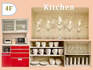 a kitchen with wine glasses on a shelf at Mezon Max Rycom in Takahara