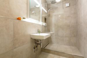 a bathroom with a sink and a mirror at Family Suite 3 Bedroom Apartment Zurich in Zürich +37 photos