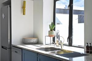 a kitchen with a sink and a window at No. 6 The Yard in Franschhoek +46 photos