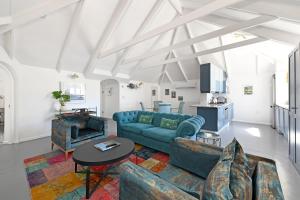 a living room with a blue couch and a table at No. 6 The Yard in Franschhoek