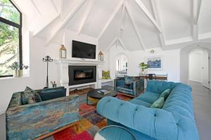 a living room with blue couches and a fireplace at No. 6 The Yard in Franschhoek