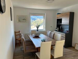 a kitchen and dining room with a wooden table and chairs at Pölstaler Berghütte in Oberzeiring +60 photos