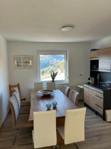 a kitchen and dining room with a table and chairs at Pölstaler Berghütte in Oberzeiring