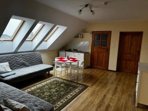 a living room with a couch and a table at Willa Kumat in Brańsk