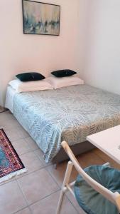 a bedroom with a bed and a table at Lovely view in Nice