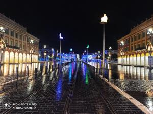 a city street lit up at night with lights at Lovely view in Nice