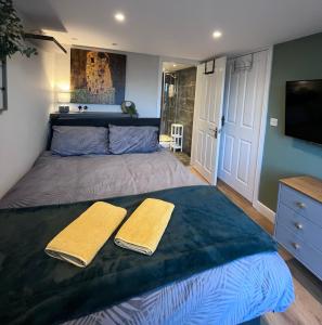 a bedroom with a large bed with two towels on it at Bryn Haul Sunny Hill in Trearddur