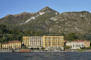a group of buildings in front of a mountain at The Lake Como EDITION in Griante Cadenabbia