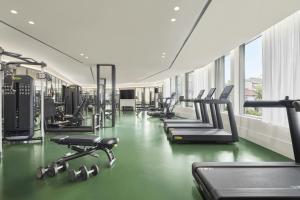 a gym with a row of treadmills and machines at The Lake Como EDITION in Griante Cadenabbia +26 photos