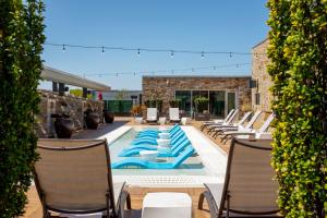 a patio with chairs and a swimming pool at Archer Hotel Napa in Napa