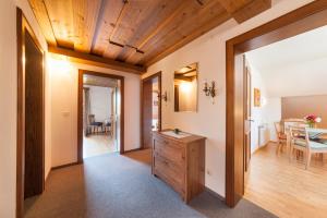 a hallway with a wooden ceiling and a dining room at Chalet in Sankt Gilgen