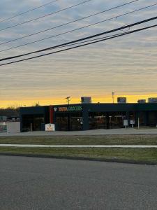 a large building with a sign on the front of it at The Porchlight retreat in Farmington Hills