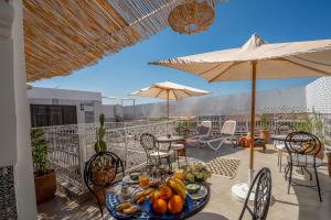a table with a plate of fruit on a balcony at Riad HAFSSA & Spa in Marrakech