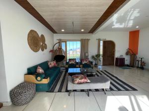 a living room with a couch and a table at Luxury KA Villa - BIR in Bīr