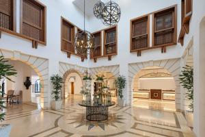 a lobby with a table with flowers on it at Pine Cliffs Hotel, a Luxury Collection Resort, Algarve in Albufeira +198 photos