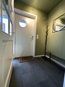 a hallway with a white door and a window at Aurora Borealis Apartment - Sleeps 3 - Parking in Hjorten
