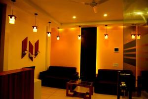 a living room with a couch and a table at Homey Residency vythiri in Padinjarathara