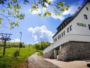 a white building with a stone facade and a road at Q-Stall, Apartment 05 in Brilon