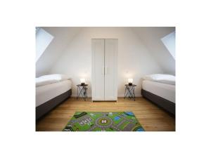 a room with two beds and a rug at Q-Stall, Apartment 05 in Brilon