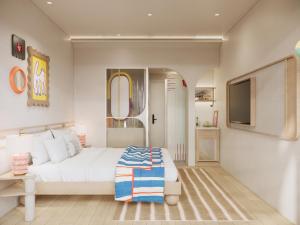 a bedroom with a white bed and a tv at Savvy by M Village Hai Ba Trung - Saigon Downtown in Ho Chi Minh City