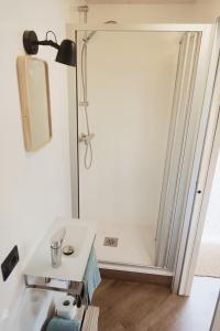 a bathroom with a shower and a white table at Rallentare immersi nel verde di Cima Lan 