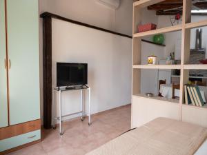 a living room with a tv and a bed at Holiday Home in Siracusa with garden in Floridia