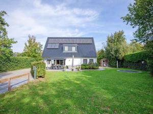 una casa con techo solar en un patio en Lovely villa on the edge of the forest, en Westermient