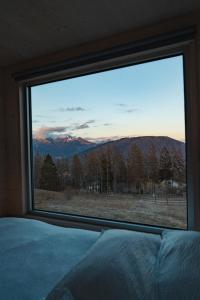 a bedroom window with a view of a mountain at Rallentare immersi nel verde di Cima Lan 