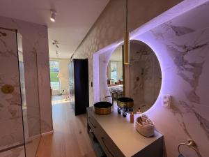 a bathroom with a vanity with a mirror and a shower at Beach House in Ardennes in Chaudfontaine
